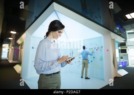 Female executive using digital tablet Stock Photo