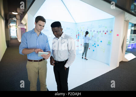 Male executives using digital tablet Stock Photo