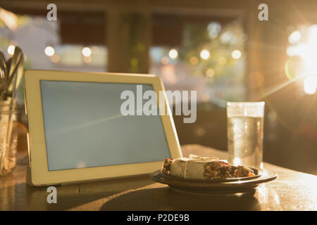 Digital tablet and breakfast on table Stock Photo