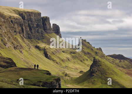 Quiraing, Isle of Skye, Scotland - Bizarre rocky landscape with two human figures standing on a cliff in the foreground Stock Photo