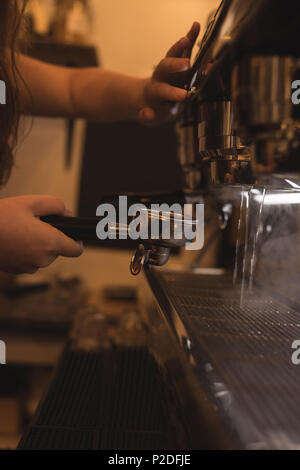 Barista making coffee in cafe Stock Photo