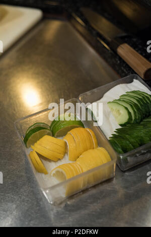 Sliced vegetables kept on kitchen counter Stock Photo