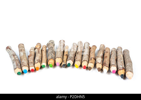 Close up of handmade wooden color pencils on white background. Stock Photo