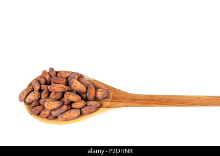 Close up of cocoa beans in wooden spoon on white background. Stock Photo