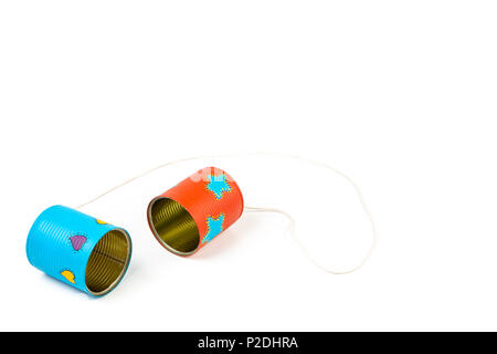 Close up of colourful hand painted can telephone toy on white background. Stock Photo