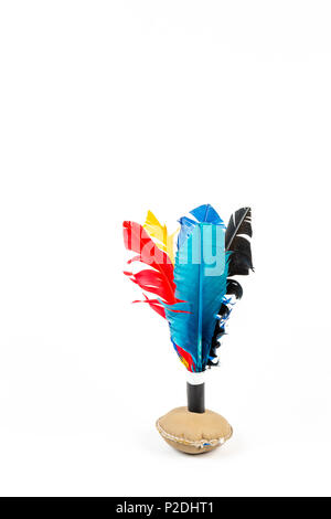 Close up of handmade shuttlecock toy with colorful feathers on white background. Stock Photo