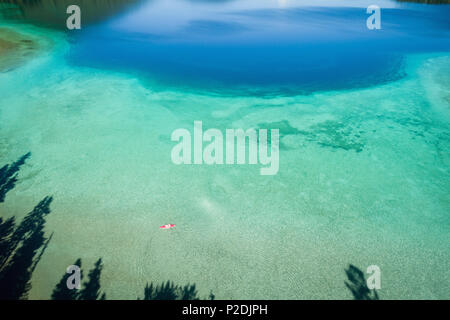 Turquoise water in the shallow banks along the coast line Stock Photo