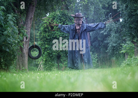 Scary scarecrow in a hat Stock Photo