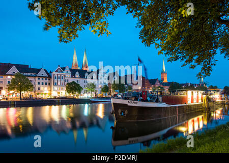 View over river Trave at night towards the old town with the church of St Mary and church of St. Peter, Hanseatic City, Luebeck, Stock Photo