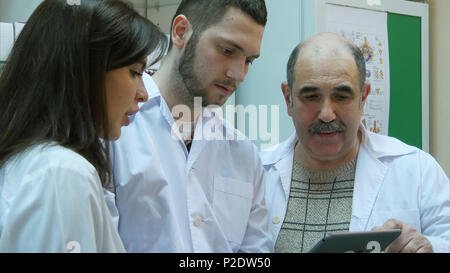 Pharmacists using digital tablet while checking medicine in pharmacy Stock Photo