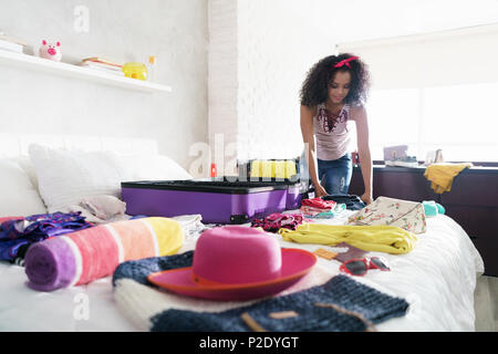 Pretty Young Black Woman Packing Bags For Holidays
