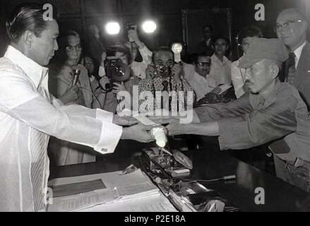 . English: Japanese imperial army soldier Hiroo Onoda (R) offering his military sword to Philippine President Ferdinand E. Marcos (L) on the day of his surrender, March 11, 1974. 17 September 2015. Malacañang Palace 43 President Marcos and Hiroo Onoda Stock Photo