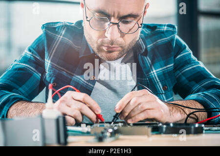 Male engineer testing circuit board Stock Photo