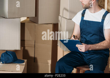 Delivery man filling cargo declaration Stock Photo