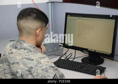A U.S. Air Force Senior Airman from the 355th Communications Squadron installs Windows Server 2008 on a print server at Davis-Monthan Air Force Base, Arizona, on September 7, 2016. The network operations team ensures compliance with Defense Information Systems Agency standards, performing hardware installation, software deployment, scripting configuration, system maintenance, and security management for base network operations. Stock Photo