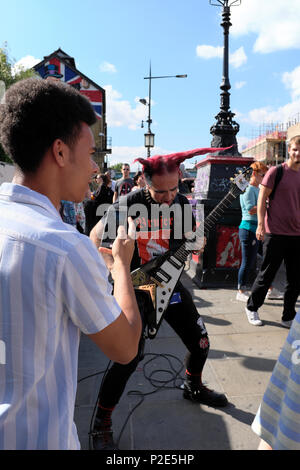 Punk rocker busking, Camden Town, Camden, London, UK Stock Photo