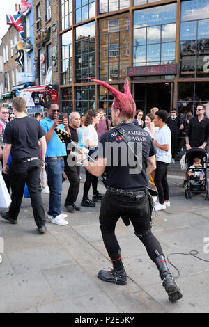 Punk rocker busking, Camden Town, Camden, London, UK Stock Photo