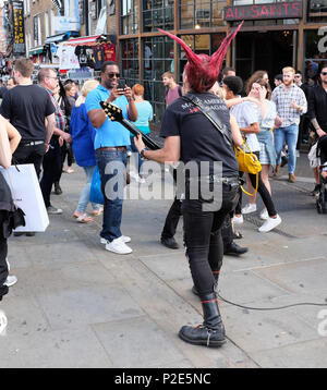 Punk rocker busking, Camden Town, Camden, London, UK Stock Photo