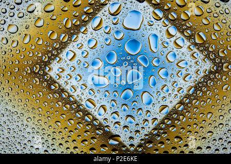 Close up of a water drops on a blue and brown gradient background, covered with drops of water -condensation. Stock Photo