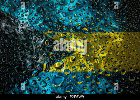 Close-up of a drop of water against a background of the national flag of Bahamas on an isolated background Stock Photo