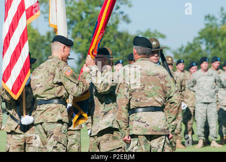 Division Command Sergeant Major Todd Sims congratulates and gives a ...