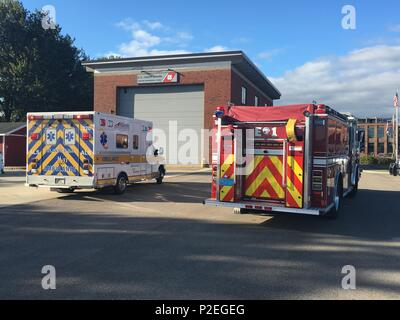 A Newburyport Fire Department truck and ambulance sit parked outside of Coast Guard Station Marrimack River, Friday, Sept. 16, 2016 in Newburyport, Massachusetts. The ambulance was used to transport two people who were injured after their boat ran aground at the mouth of the Merrimack River. U.S. Coast Guard courtesy photo Stock Photo