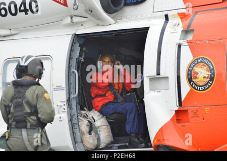 Rear Adm. Meredith Austin, Commander, 5th Coast Guard District, prepares for launch aboard an MH-60 Jayhawk helicopter at Base Portsmouth in Portsmouth, Virginia, Sept. 3, 2016, to view various locations within the 5th District area of responsibility in the wake of Tropical Storm Hermine. The Coast Guard is in the process of assessing storm damage in Virginia and North Carolina. (U.S. Coast Guard photo by Petty Officer 2nd Class Nate Littlejohn) Stock Photo