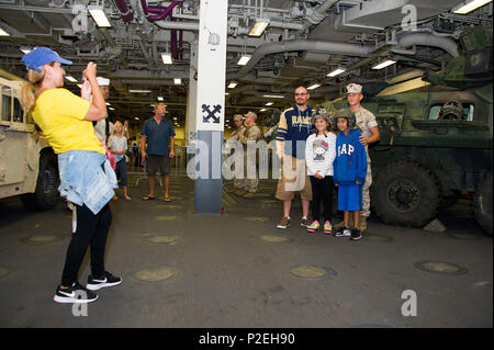 160904-N-JH668-086 SAN PEDRO, California (Sept. 4, 2016) – A Los Angeles family takes photos while touring amphibious assault ship USS America (LHA 6), during the inaugural Los Angeles Fleet Week. Fleet week offers the public an opportunity to tour ships, meet Sailors, Marines, and members of the Coast Guard and gain a better understanding of how the sea service support the national defense of the United States and freedom of the seas. (U.S Navy photo by Mass Communication Specialist 3rd Class Kyle Hafer/Released) Stock Photo