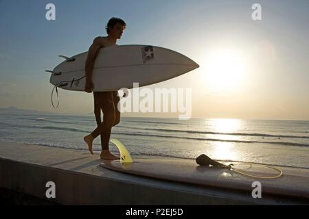 France, Pyrenees Atlantiques, Pays Basque, Biarritz, surfer on sunset in front of the Basques coast beach Stock Photo