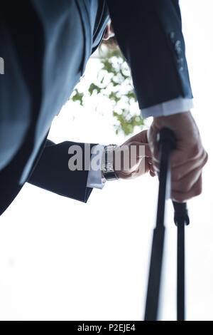 Businessman checking time on wrist watch Stock Photo