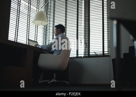 Businessman using laptop at table Stock Photo