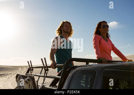 Couple standing in jeep Stock Photo