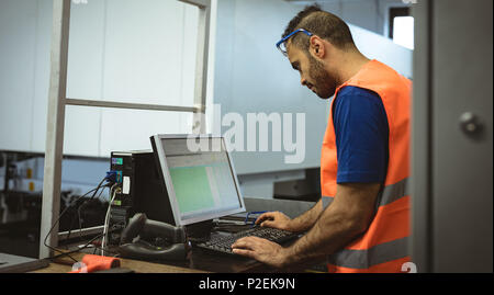 Male worker working on computer Stock Photo