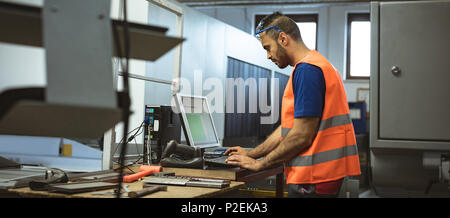 Male worker working on computer Stock Photo