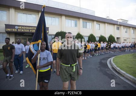 Marine Maj. Gen. Charles Chiarotti, US Forces, Japan commander, and Army Sgt. 1st Class Donna Cook, USFJ first sergeant, lead for the formation after completing the USFJ Command 5K Run at Yokota Air Base, Japan, Sept. 9, 2016. Over 100 service member participated in the run, which concluded with the retirement of the old USFJ colors and the unveiling of the new USFJ colors. (U.S. Air Force photo by Yasuo Osakabe/Released) Stock Photo