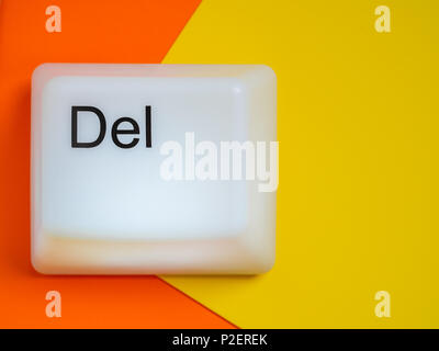 Flat Lay of Big Delete Computer Key Button Light Box Isolated on Yellow and Orange Background with Space. Eraser Concept. Stock Photo