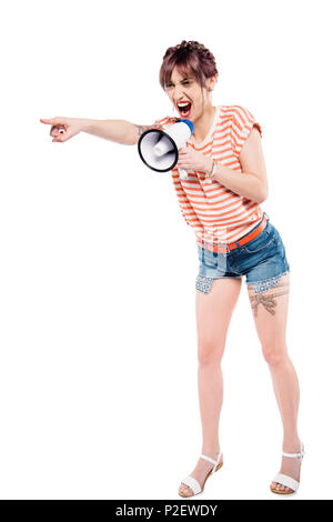 screaming young woman with loudspeaker pointing away isolated on white Stock Photo