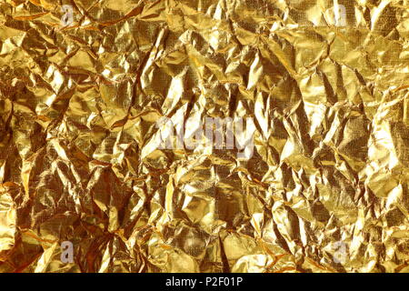 Close up of gold paper wrinkled background texture Stock Photo