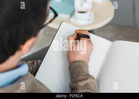 Close-up view of psychotherapist making notes of patient complaints Stock Photo
