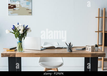Modern workplace with laptop on wooden table in office Stock Photo