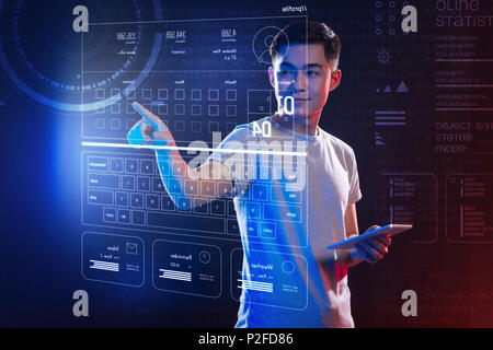 Smiling IT manager feeling confident while using the hologram Stock Photo