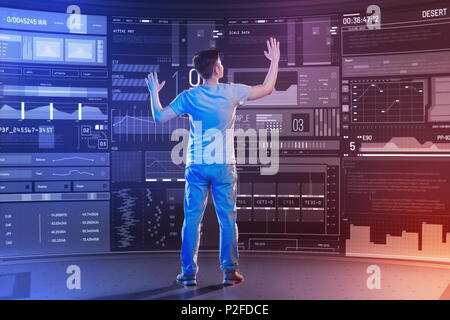 Serious software developer putting his hands up while working in a modern office Stock Photo