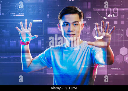 Professional web developer working with holographic images and looking impressed Stock Photo