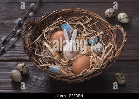 high angle view of chicken and quail easter eggs and rabbit in nest Stock Photo