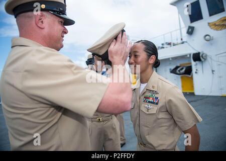 160916-M-TM809-819 PACIFIC OCEAN (Sept. 16, 2016) Chief Aviation Electrician’s Mate Sean Almond, from New Harmony, Indiana, places a cover on Chief Hospital Corpsman Claudette Arenas, from Las Vegas, during the chief pinning ceremony on the flight deck of hospital ship USNS Mercy (T-AH 19). Four hospital corpsman attached to Mercy were promoted to the rank of chief petty officer. Deployed in support of Pacific Partnership 2016, Mercy is sailing to her homeport of San Diego. (U.S. Marine Corps photo by Sgt. Brittney Vella/Released)
