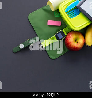 Backpack with school supplies on black background. Top view Flat lay Stock Photo
