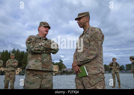 Lt. Col. Johnny A. Evans Jr., commander of the 3rd Battalion, 69th Armor Regiment, talks to Maj. Gen. Duane Gamble, commander of the 21st Theatre Sustainment Command, about EAS (European Activity Set) turn in at Camp Adazi, Latvia, September 20, 2016. The EAS allows U.S. rotational forces in the region to move more quickly and easily to participate in training and exercises without having to bring all of their own equipment with them. 3rd Bn., 69th Arm. Rgmt., was in the region participating in Atlantic Resolve, a U.S. led effort being conducted in Eastern Europe to demonstrate U.S. commitment Stock Photo