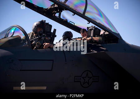 Capt. Clark Haymond, 494th Fighter Squadron pilot, and Capt. Dale Gogan, 494th FS weapon system officer, prepare themselves for a sortie in support of Tactical Leadership Programme 16-3 at Los Llanos Air Base, Spain Sep. 19. The training prepares NATO and allied forces’ flight leaders to be mission commanders, lead coalition force air strike packages, instruct allied flying and non-flying personnel in matters related to tactical composite air operations, and provide tactical air expertise to NATO agencies. (U.S. Air Force photo/ Staff Sgt. Emerson Nuñez) Stock Photo
