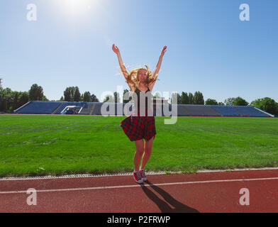 teenage girls doing sports at the stadium Stock Photo