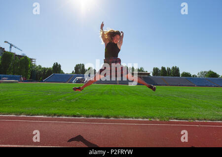 teenage girls doing sports at the stadium Stock Photo